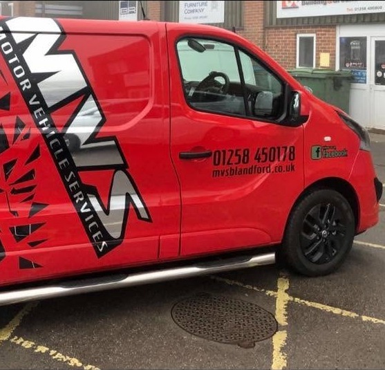 The red MVS Motor Vehicle Services van, a Vauxhall Vivaro, with 01258 450178 on the door